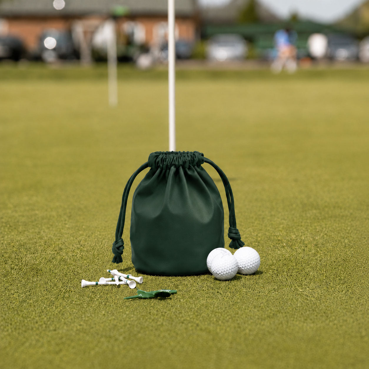 Dark Green leather golf valuables pouch with drawstring on putting green