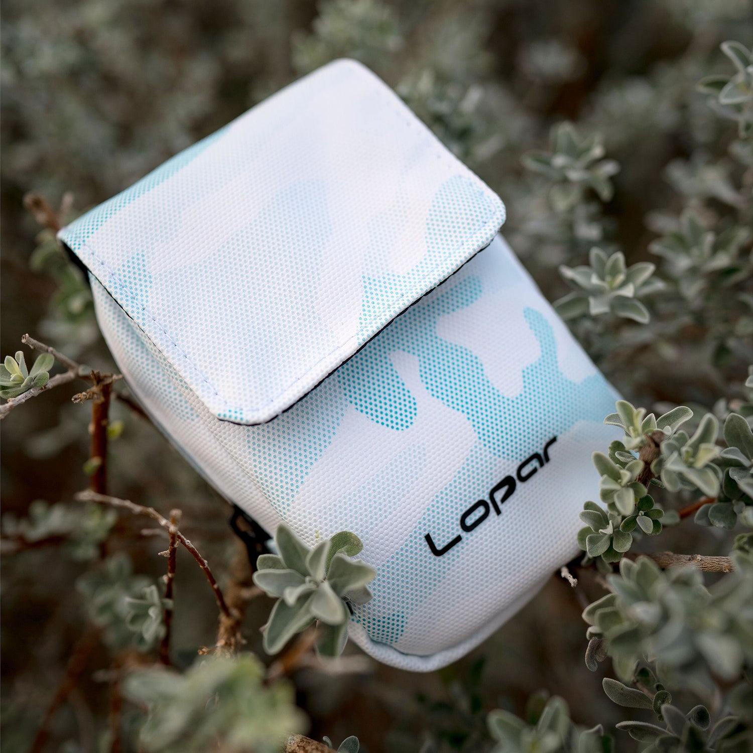 light blue rangefinder case in bushes