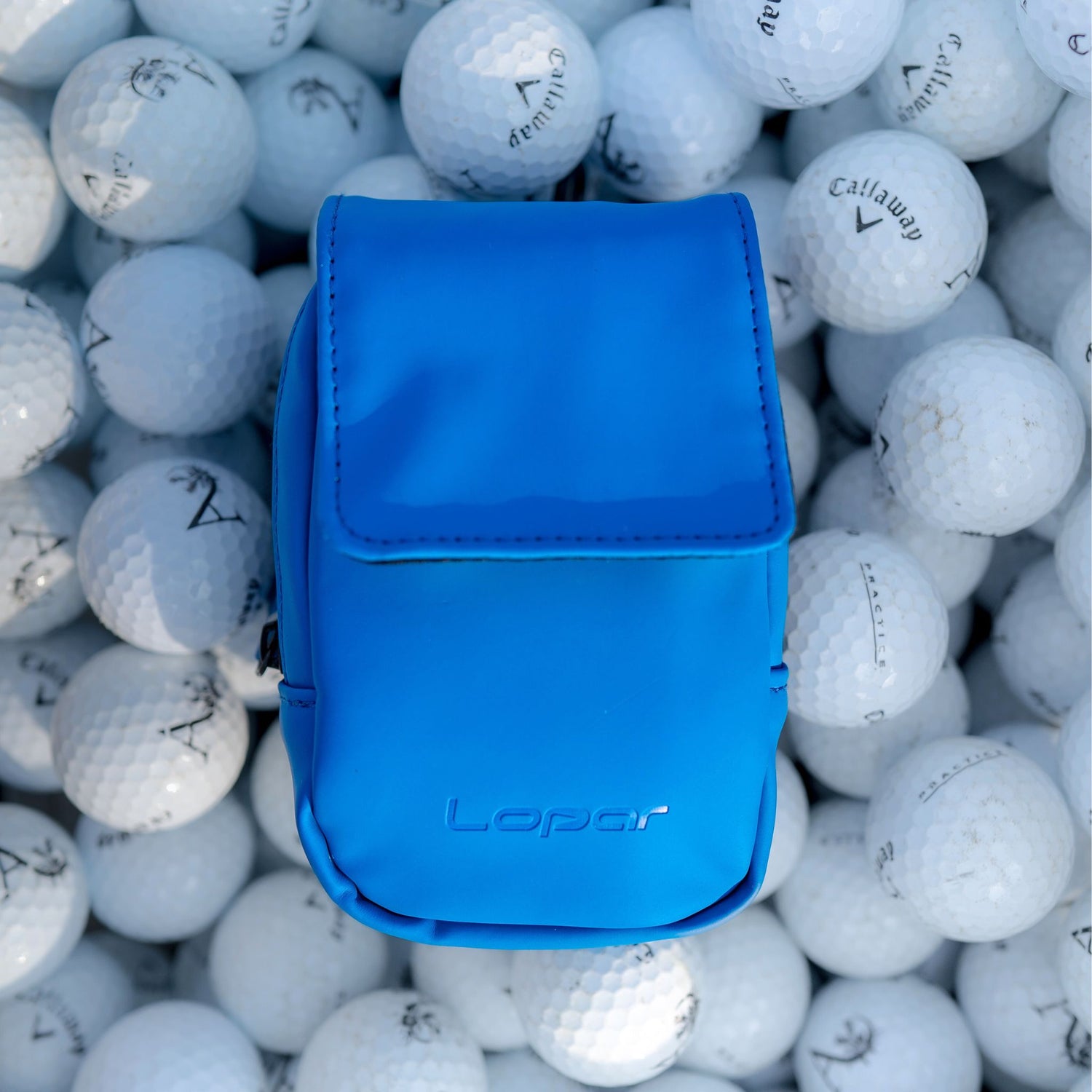 royal blue rangefinder case on golf balls